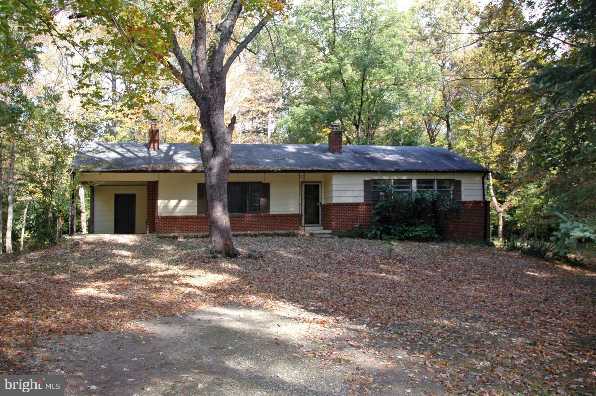 a view of a house with a tree in front of it