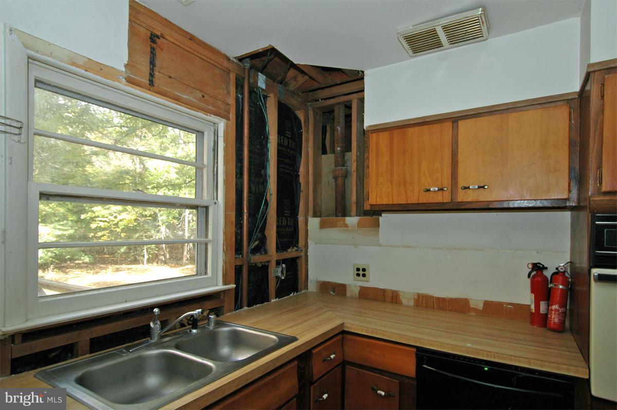 15102 Cactus Hill Road Accokeek, MD 20607 - Photo 12 of 24 a kitchen with a sink cabinets and window