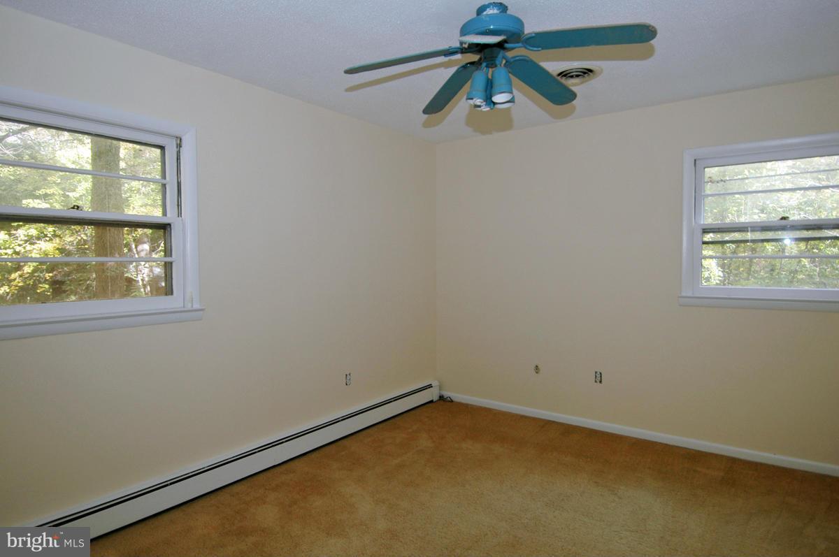 15102 Cactus Hill Road Accokeek, MD 20607 - Photo 13 of 24 an empty room with windows and fan