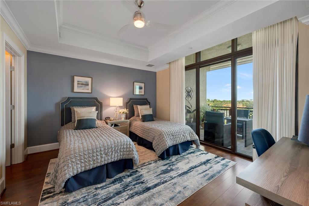 9115 Strada Place, Unit 5505 Naples, FL 34108 - Photo 14 of 44 Bedroom featuring access to exterior, dark hardwood / wood-style flooring, a raised ceiling, and ceiling fan
