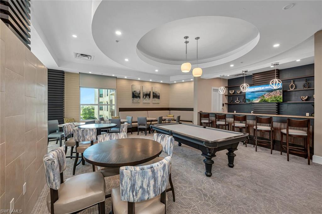 9115 Strada Place, Unit 5505 Naples, FL 34108 - Photo 29 of 44 Playroom featuring a raised ceiling, carpet, indoor bar, and billiards