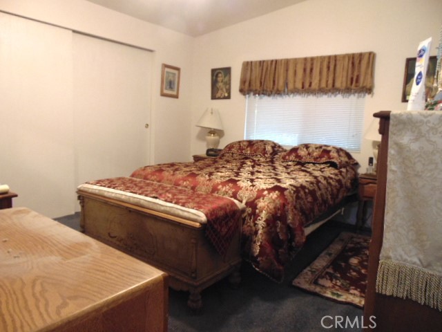 3835 Gardiner Ferry Road, Unit 62 Corning, CA 96021 - Photo 25 of 34 a bedroom with a bed and a mirror
