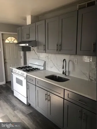 a kitchen with kitchen island a sink stainless steel appliances and cabinets