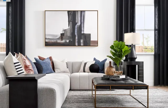 a living room with furniture and a potted plant