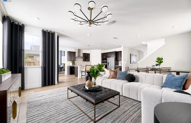 a living room with furniture potted plant and a table