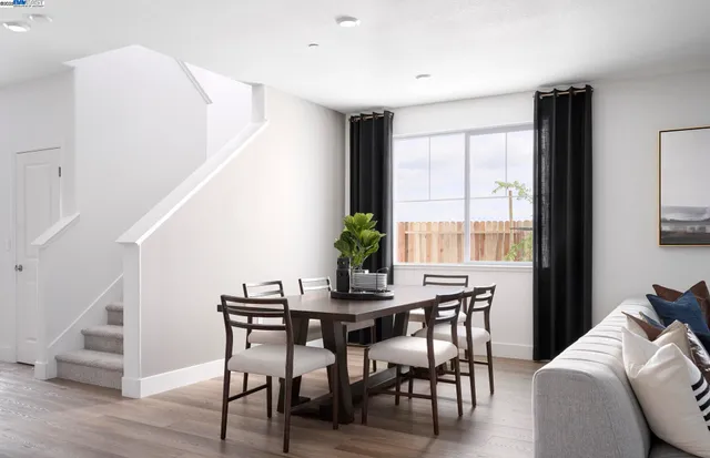 a view of a dining room with furniture window and wooden floor