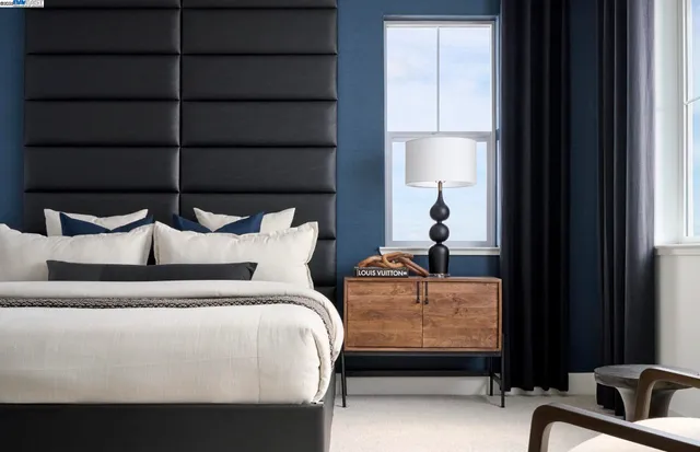 a bed room with two bed and a window