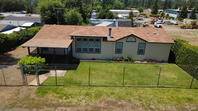 a view of house with yard and sitting area