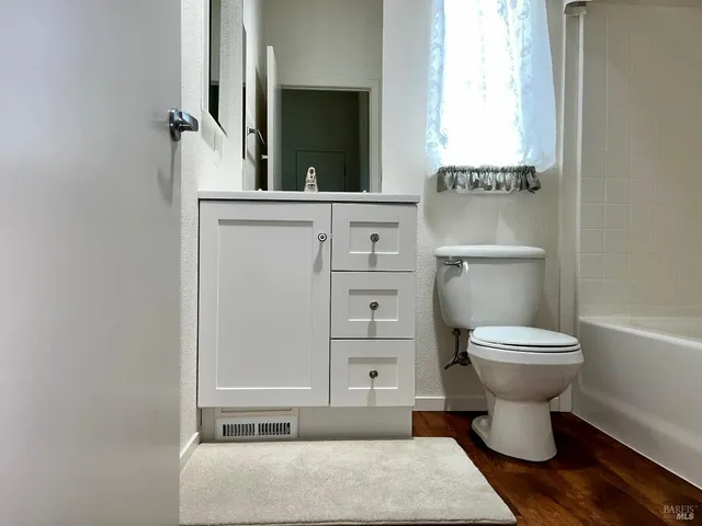a bathroom with a toilet a sink and a mirror