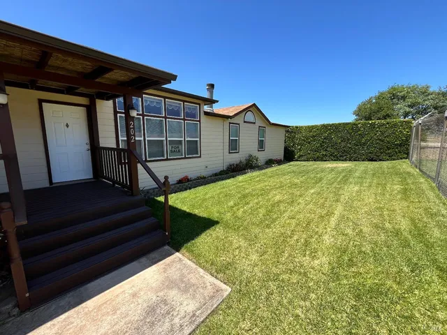 a view of backyard with cabin