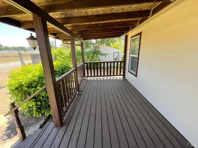 a view of balcony with wooden floor