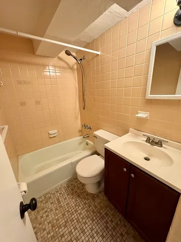 a bathroom with a sink toilet a mirror and shower