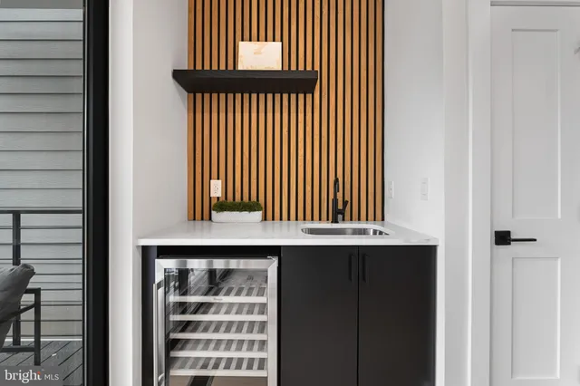 a kitchen with stainless steel appliances kitchen island granite countertop a large stove a sink dishwasher and white cabinets with wooden floor