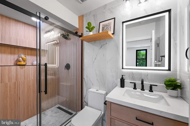 a bathroom with a glass shower door