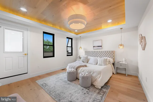 a bedroom with a bed and a chandelier