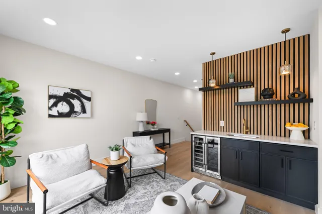 a living room with furniture a flat screen tv and a floor to ceiling window