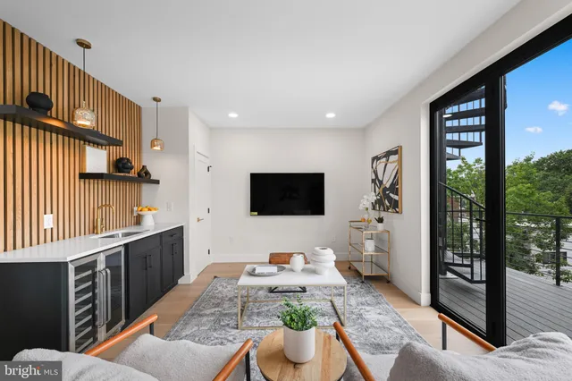 a view of balcony with wooden floor and potted plants