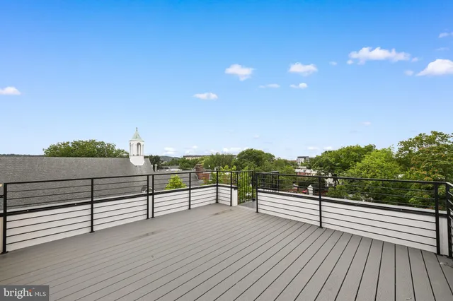 a view of balcony with wooden floor and fence