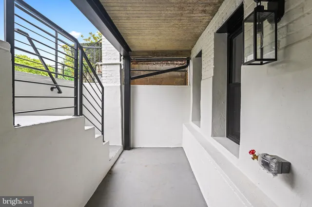 a front view of a building with a garden