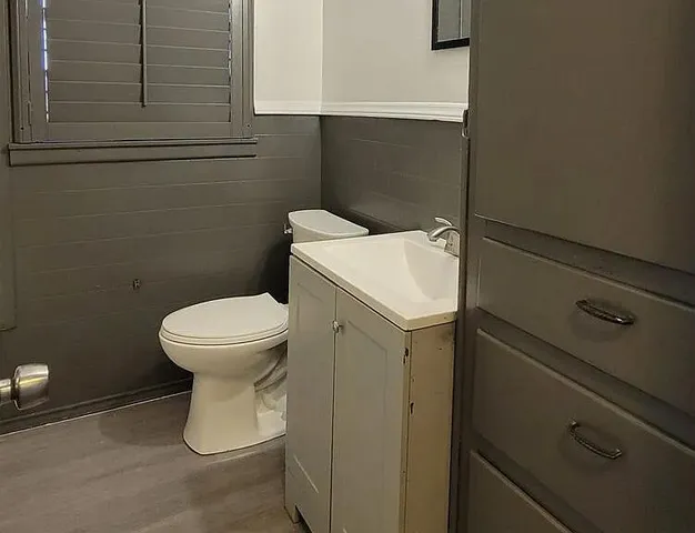 a white toilet sitting next to a sink