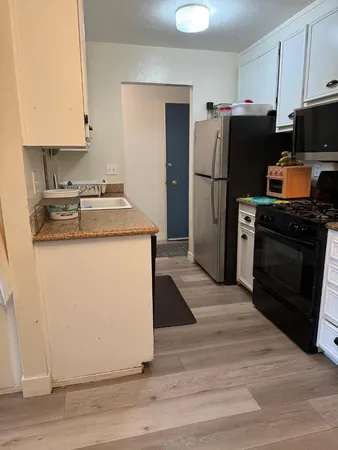 a kitchen with a refrigerator sink and stove