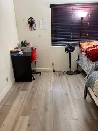 a room with wooden floor and furniture