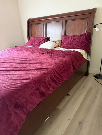 a bedroom with a bed and a mirror