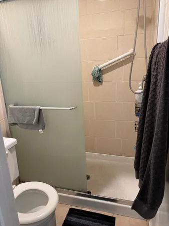 a bathroom with a toilet and a shower