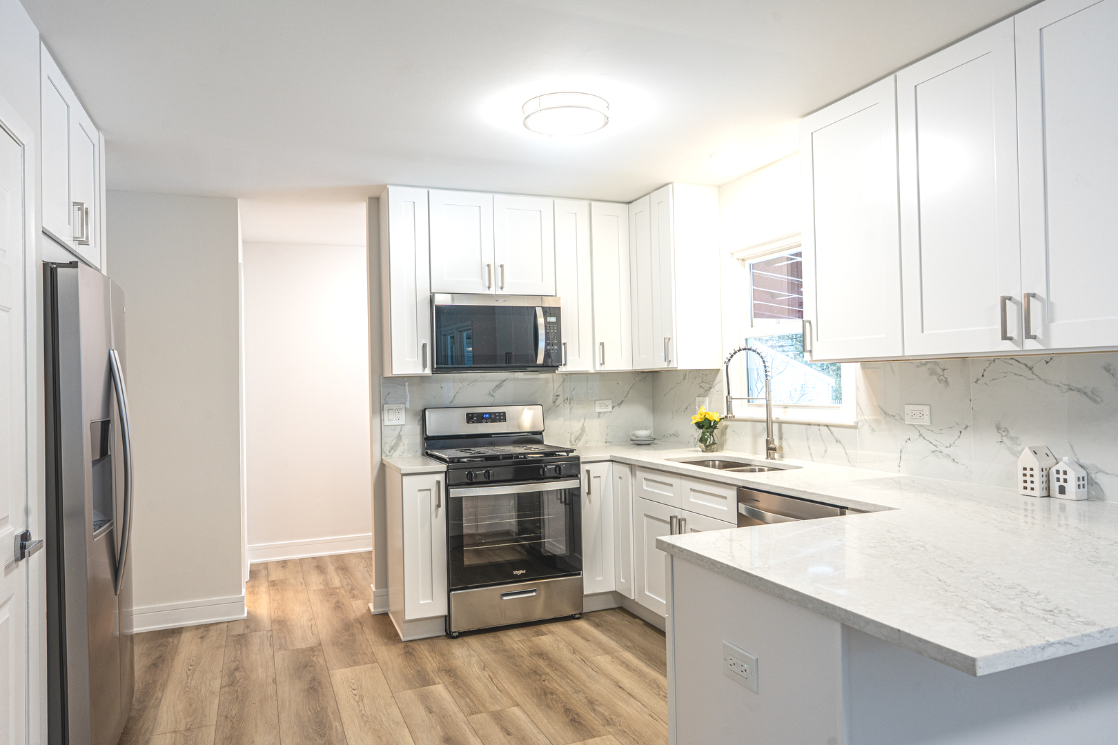 11 South Alfred Avenue Elgin, IL 60123 - Photo 6 of 22 a kitchen with a sink a stove and refrigerator