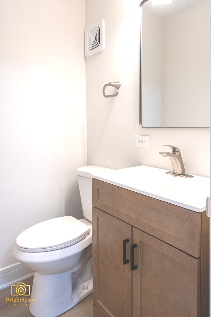 11 South Alfred Avenue Elgin, IL 60123 - Photo 7 of 22 a bathroom with a sink a toilet and mirror