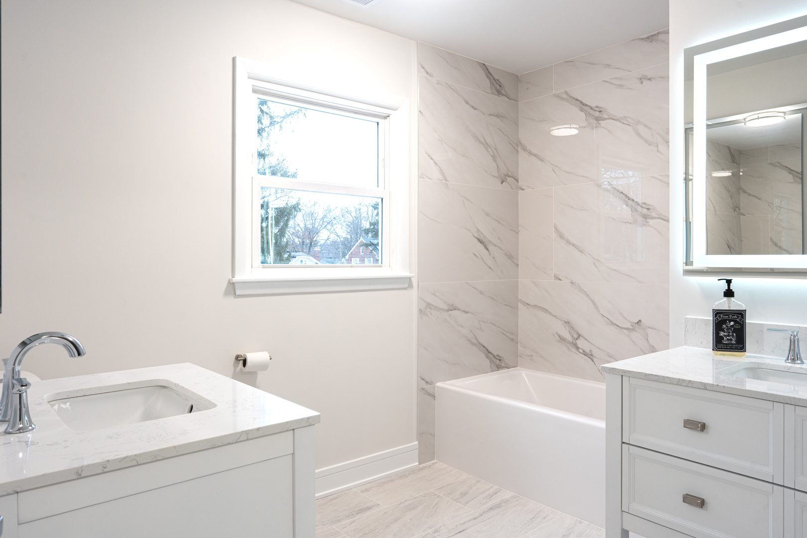 11 South Alfred Avenue Elgin, IL 60123 - Photo 10 of 22 a bathroom with a sink mirror and a bathtub