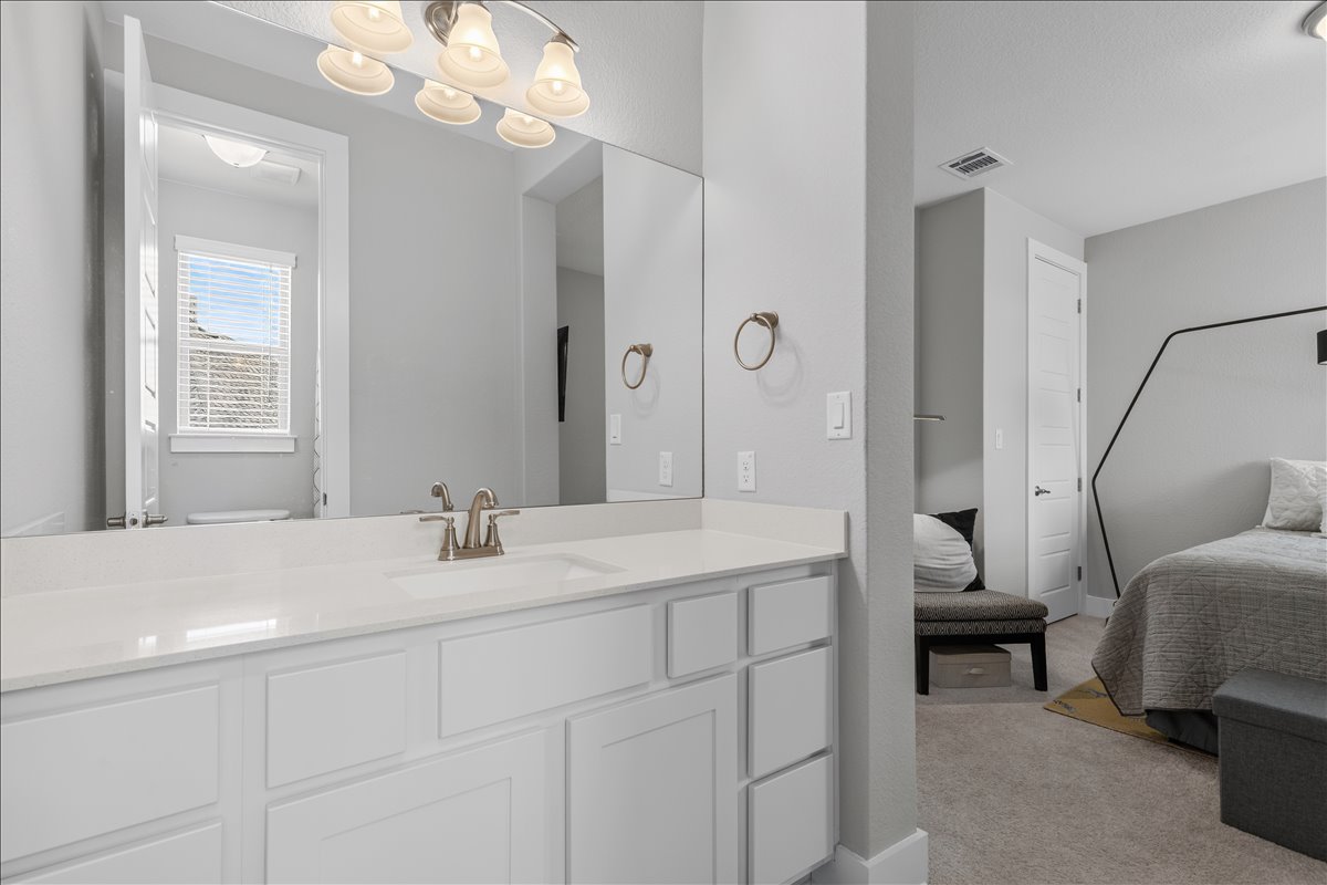 320 Raptor Beak Way Cedar Creek, TX 78612 - Photo 30 of 40 A sleek white vanity with a brushed nickel faucet defines this well-appointed primary bathroom.