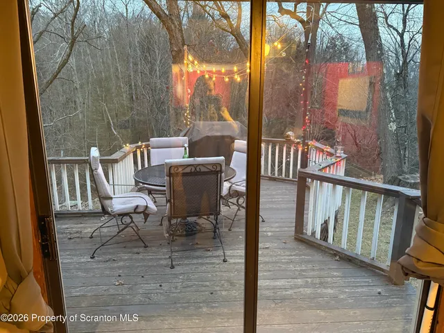 a view of balcony with wooden floor and outdoor seating