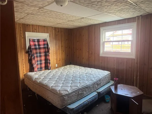 a bed sitting in a bedroom next to a window