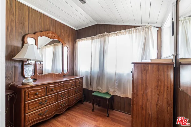 a bedroom with furniture and wooden floor
