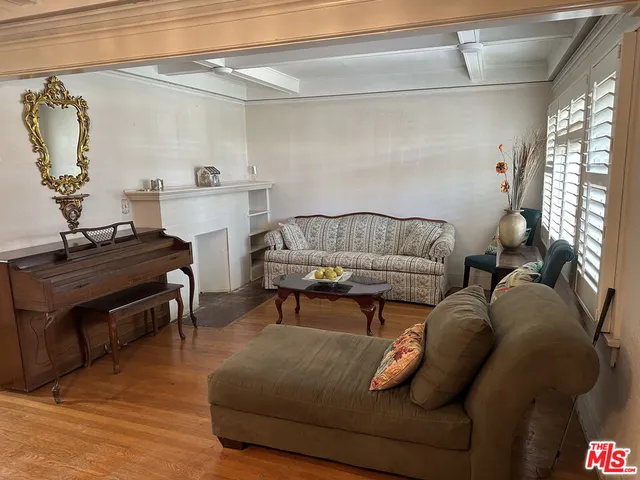 a living room with furniture and a piano