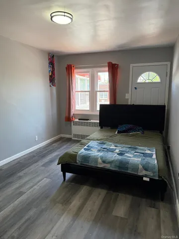 a bedroom with bed and window