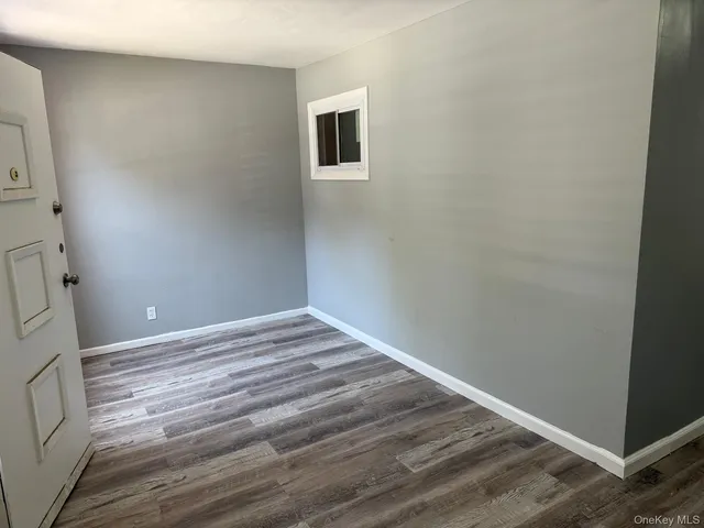 a view of a room with wooden floor and bathroom