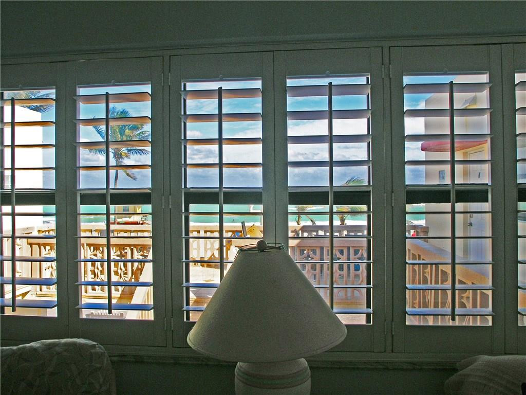 1910 North Surf Road, Unit 7 Hollywood, FL 33019 - Photo 7 of 17 a living room filled with furniture and a large window