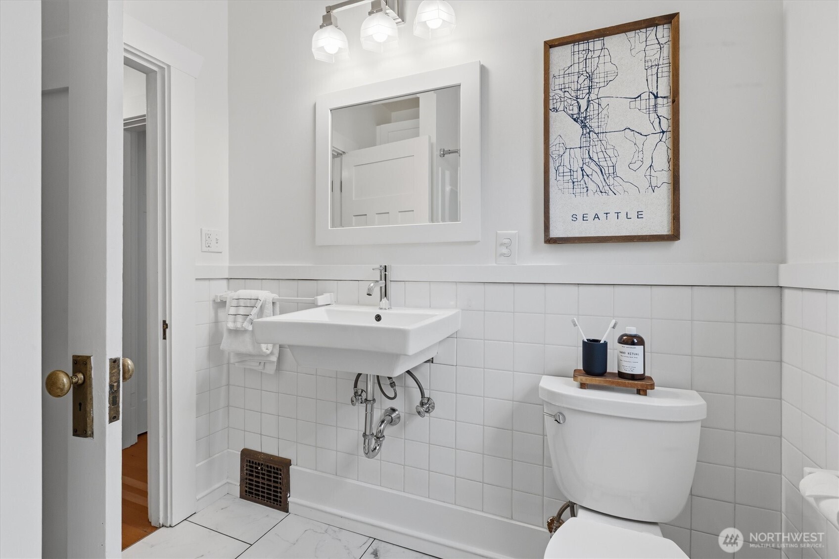 715 North 48th Street Seattle, WA 98103 - Photo 11 of 37 a bathroom with a sink toilet and shower