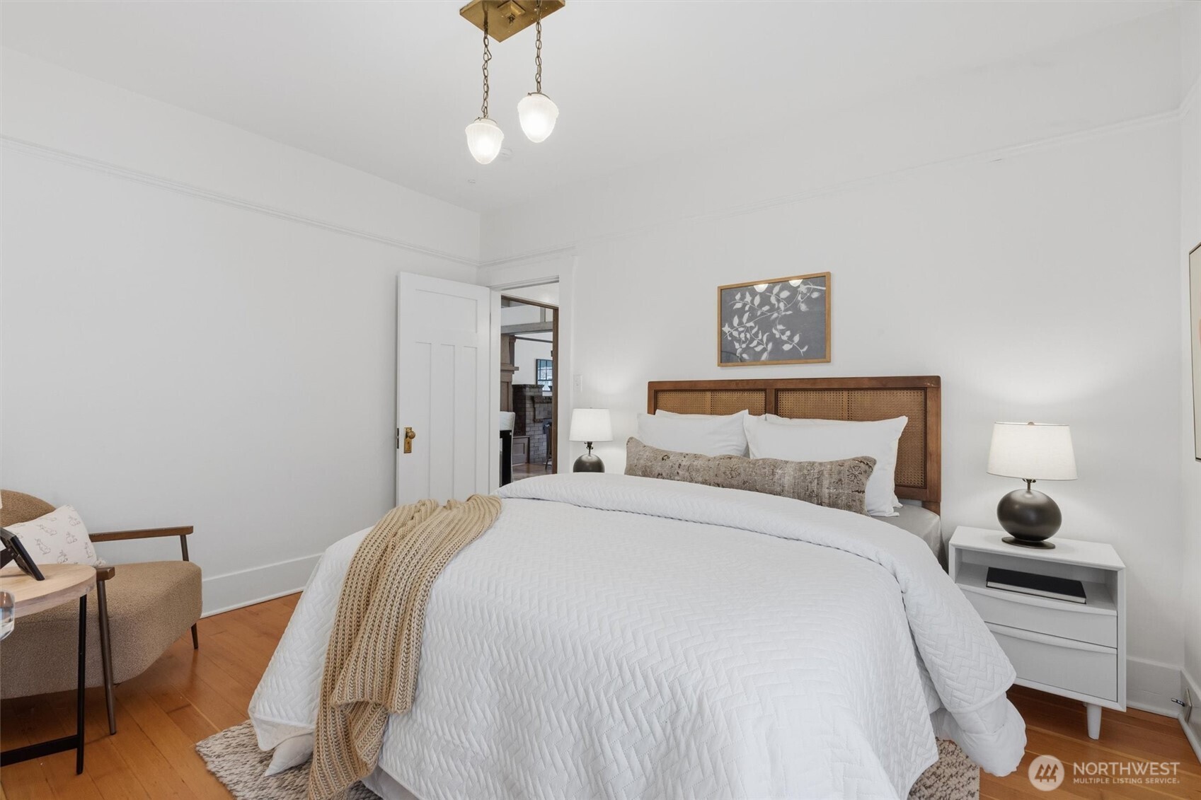 715 North 48th Street Seattle, WA 98103 - Photo 12 of 37 a bedroom with a bed and a chandelier