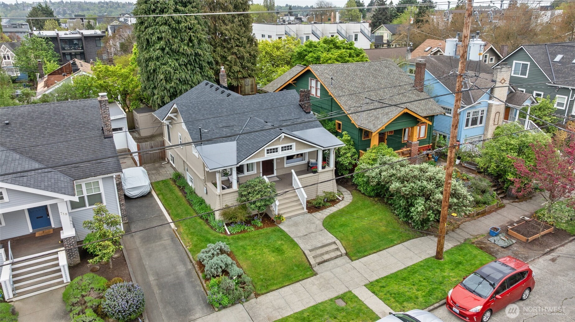 715 North 48th Street Seattle, WA 98103 - Photo 32 of 37 an aerial view of multiple houses with a yard