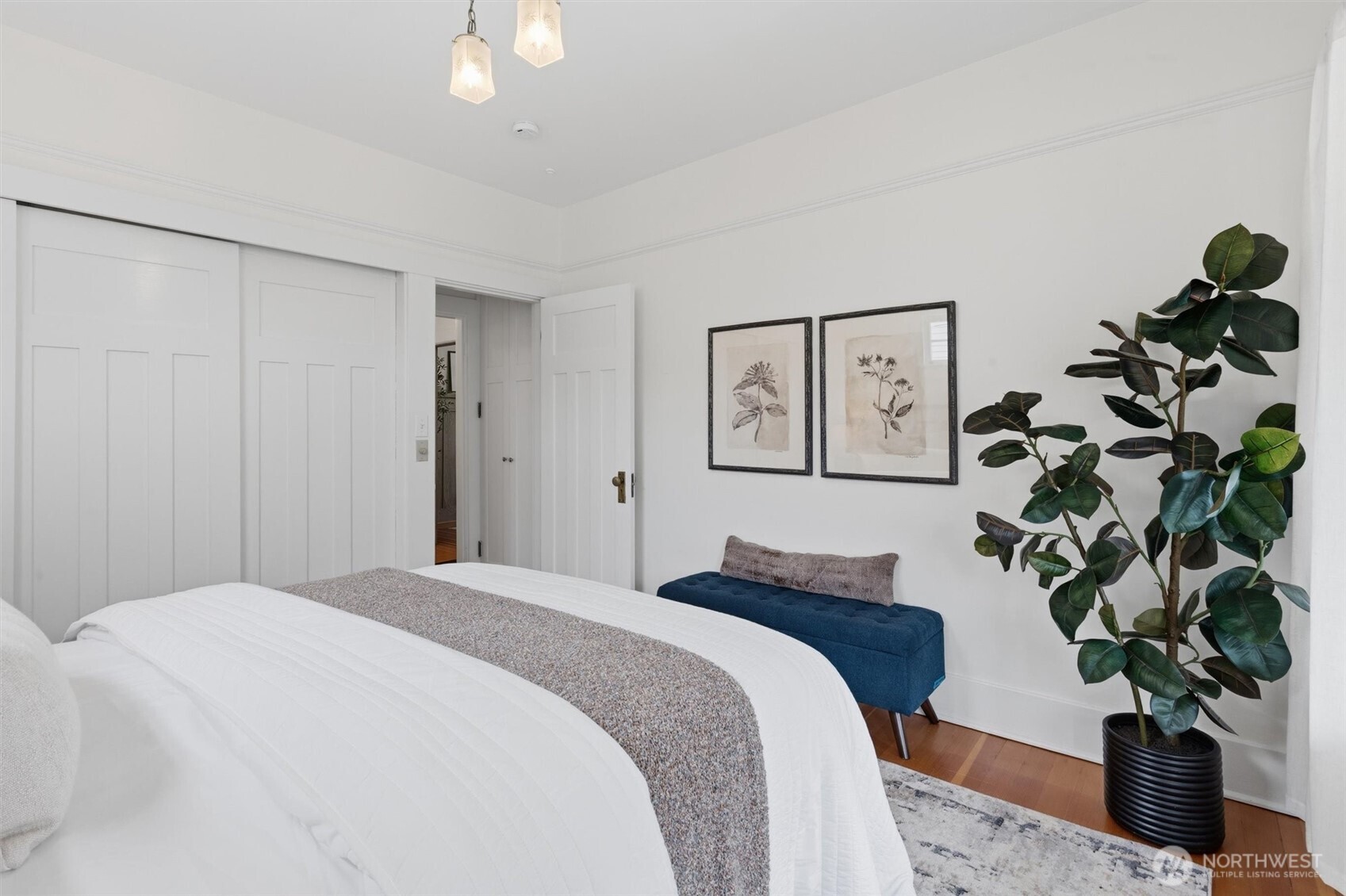 715 North 48th Street Seattle, WA 98103 - Photo 10 of 37 a bedroom with a large bed and a potted plant