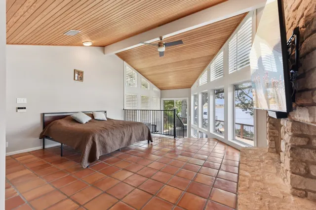 a spacious bedroom with a bed a mirror and desk