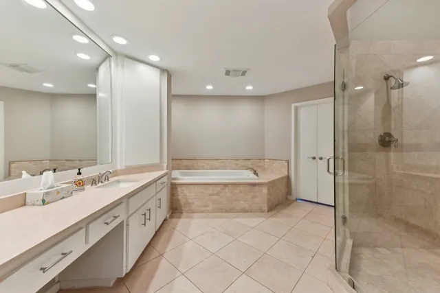 a bathroom with a granite countertop sink mirror and shower