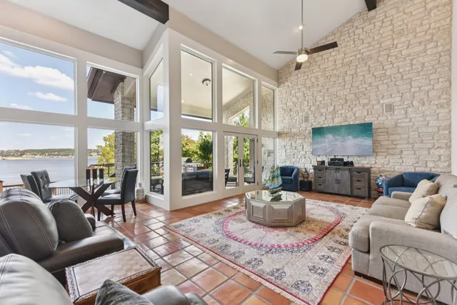 a living room with furniture a flat screen tv and a fireplace