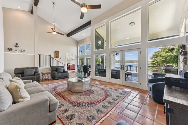a living room with patio furniture and a large window