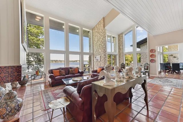 a living room with furniture and floor to ceiling windows