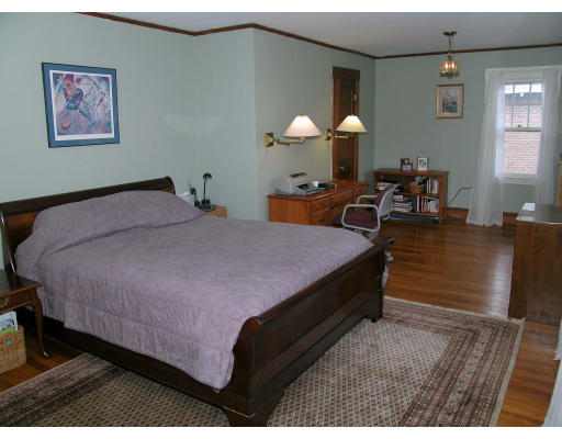 79 Withington Road Newton, MA 02460 - Photo 8 of 12 a bed room with a bed and a chandelier