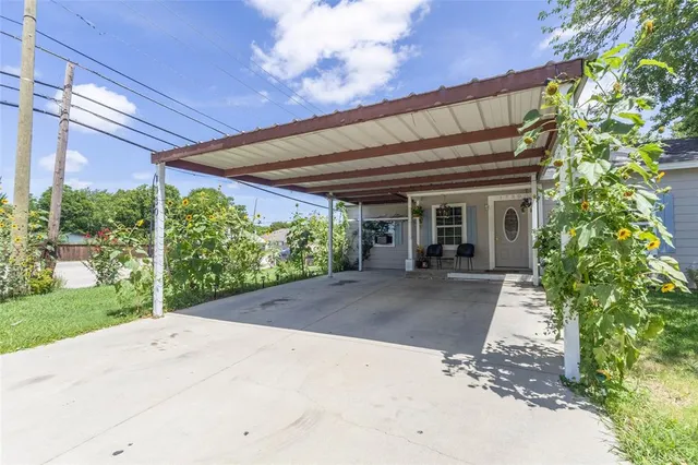 a view of a backyard with plants and a patio